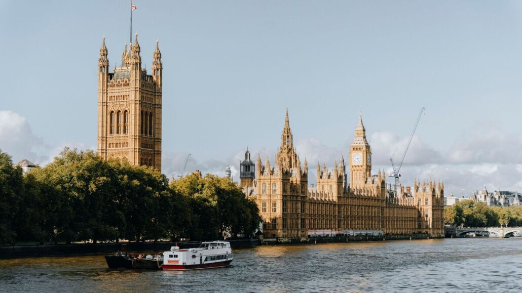 Houses of Parliament and Victoria Tower beside the River Thames in Westminster on a bright afternoon